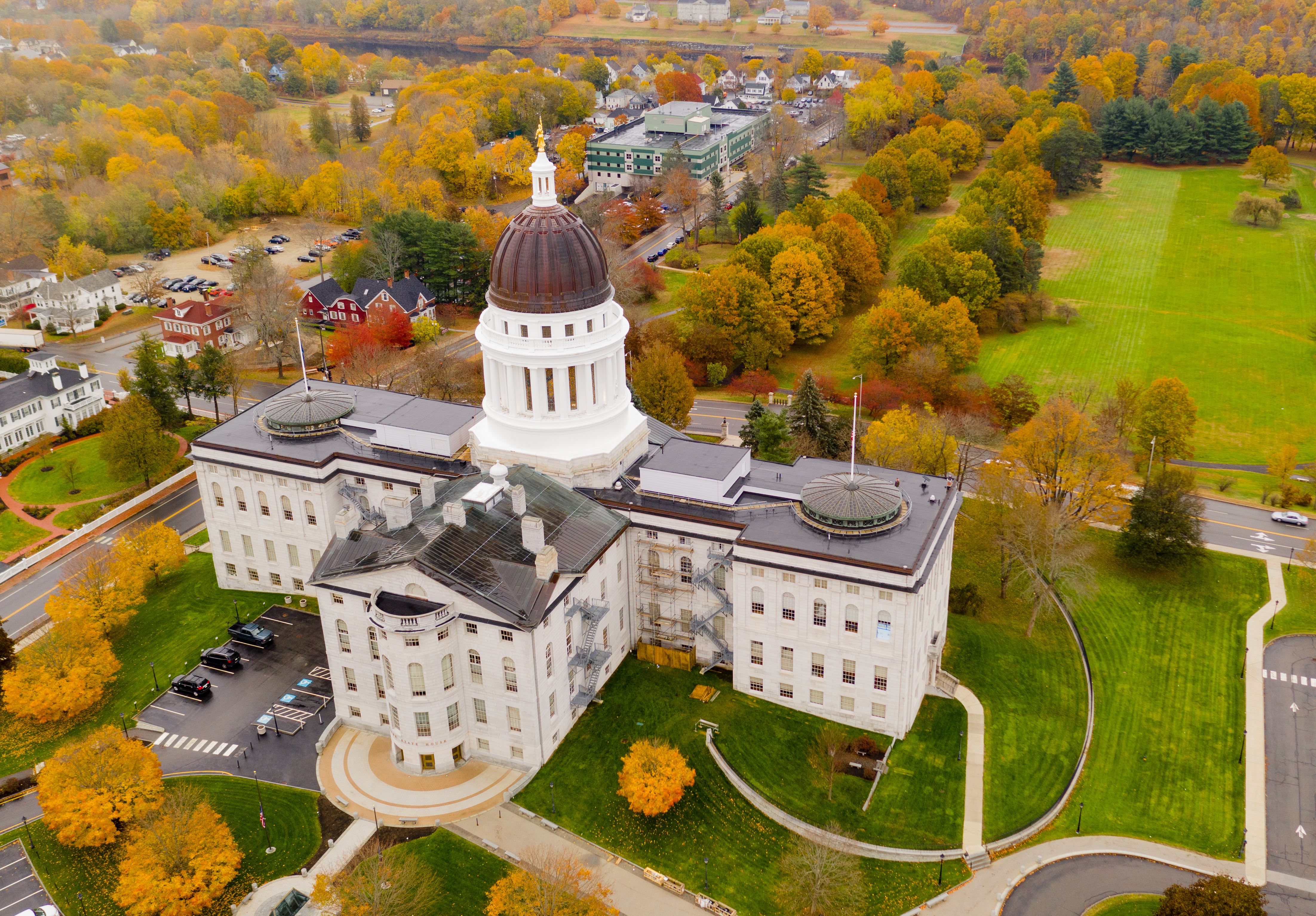 Aerial view of the Capitol building in Augusta, Maine during the fall season